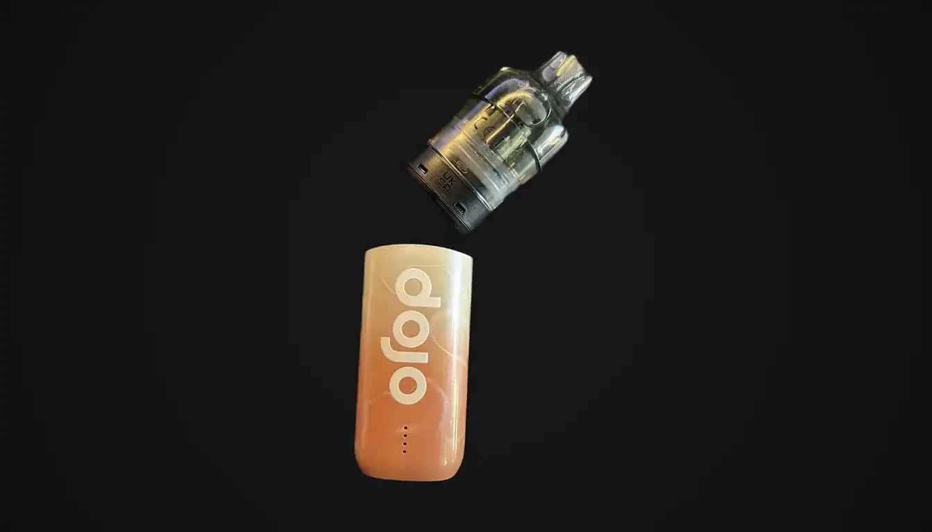 Dojo Blast 10K Fresh vape device in peach color with tank separated above on black background