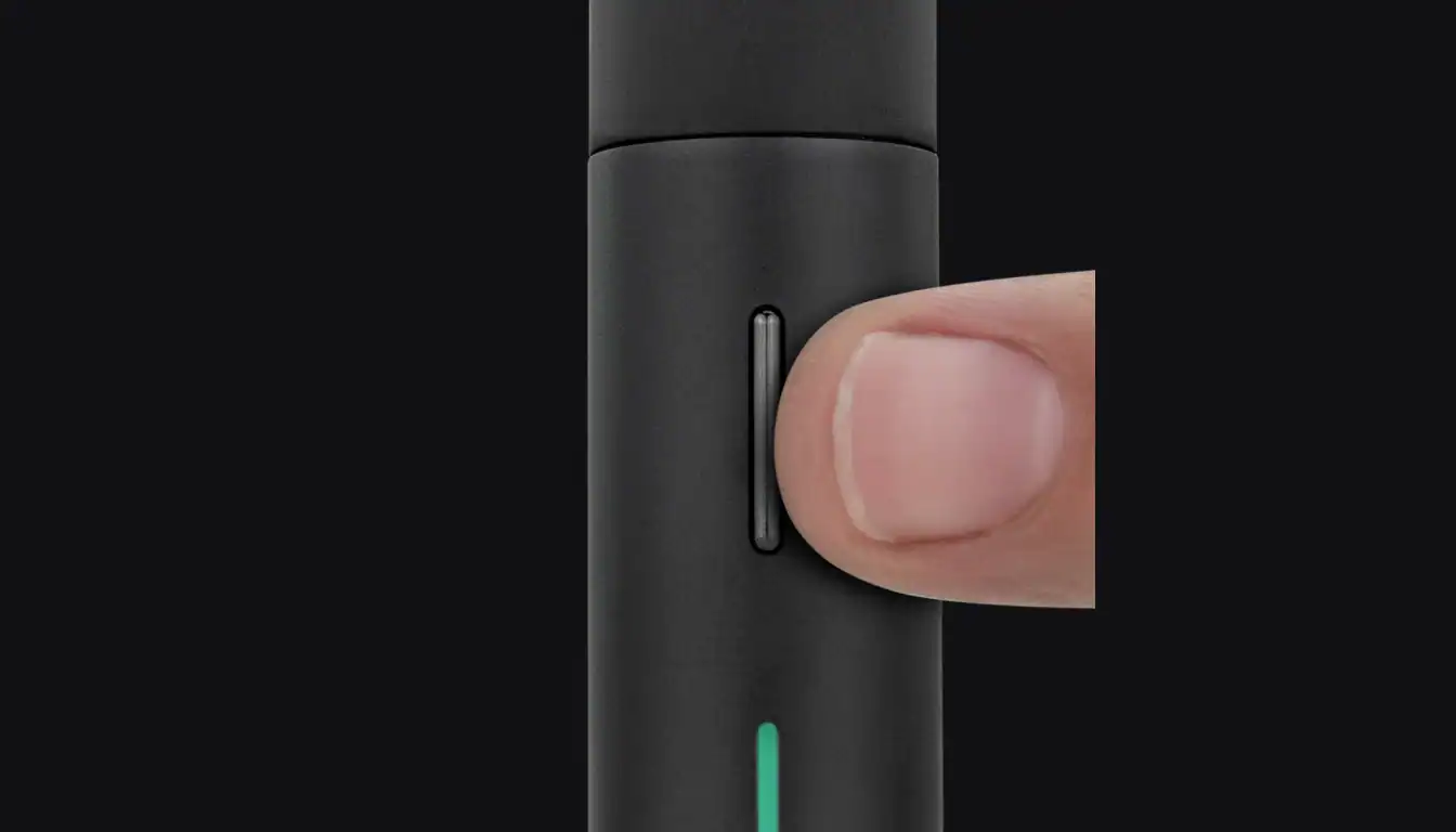Puffco Pivot device with a finger demonstrating the touch-sensitive control panel area
