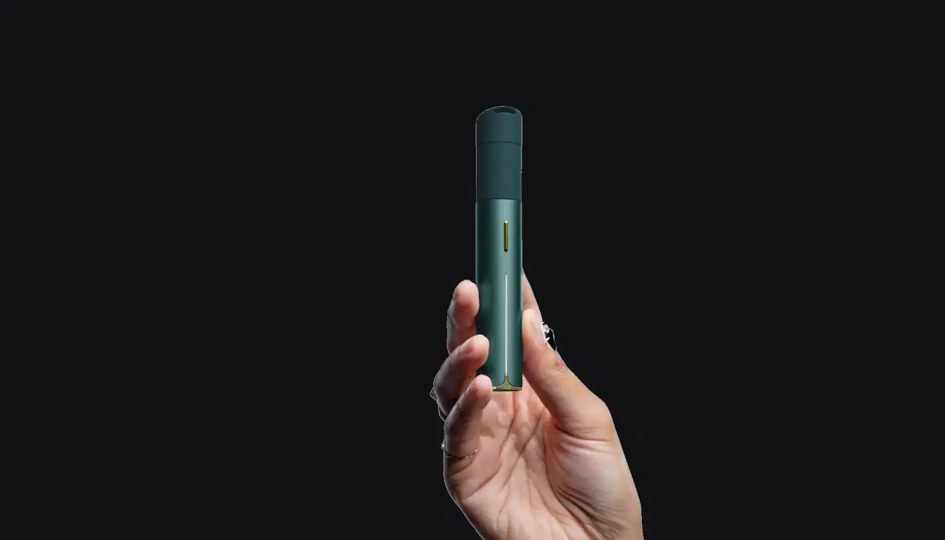 Puffco Pivot teal vape device held in hand against black background, front view